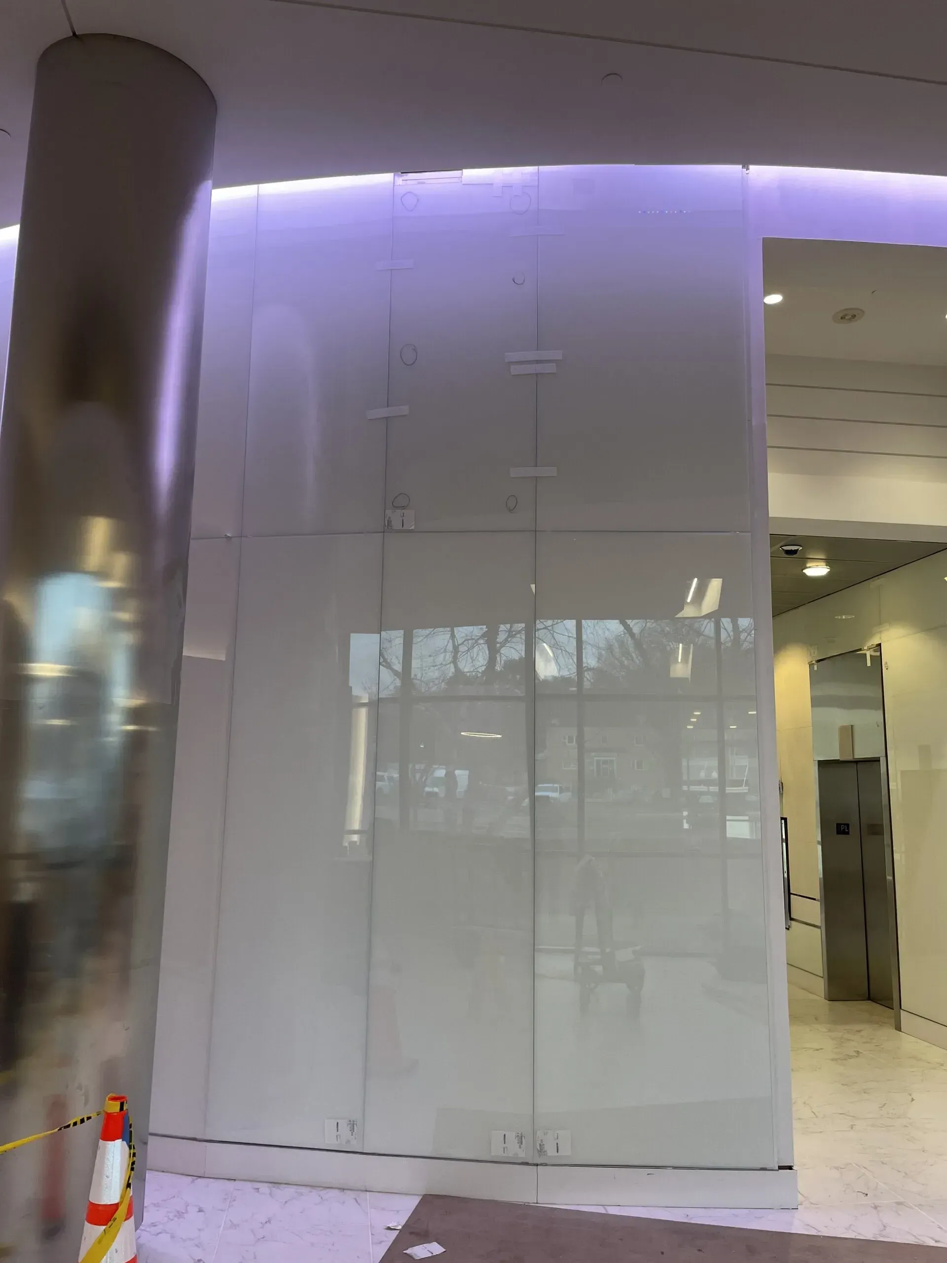 A white wall with a purple light behind it