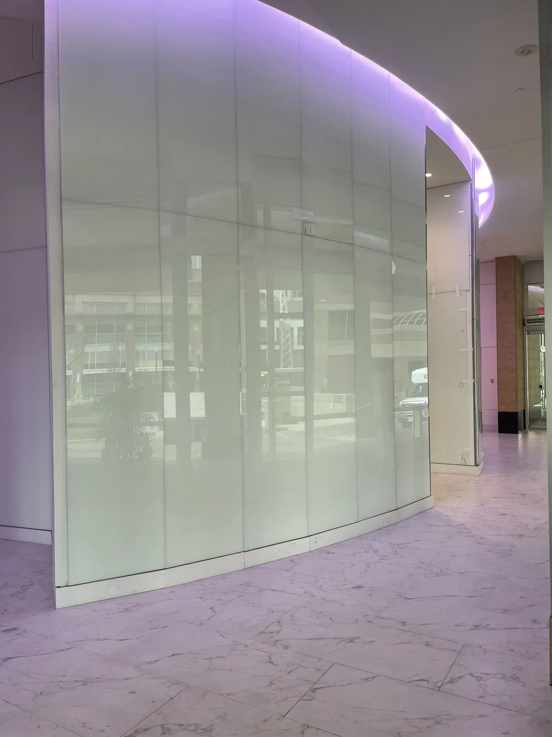 A white wall with a purple light behind it