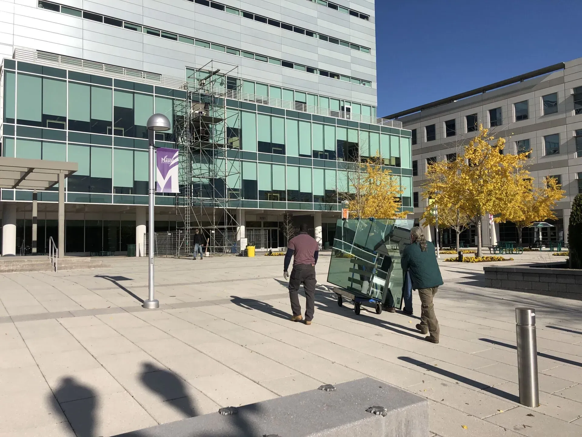A group of people are walking in front of a building