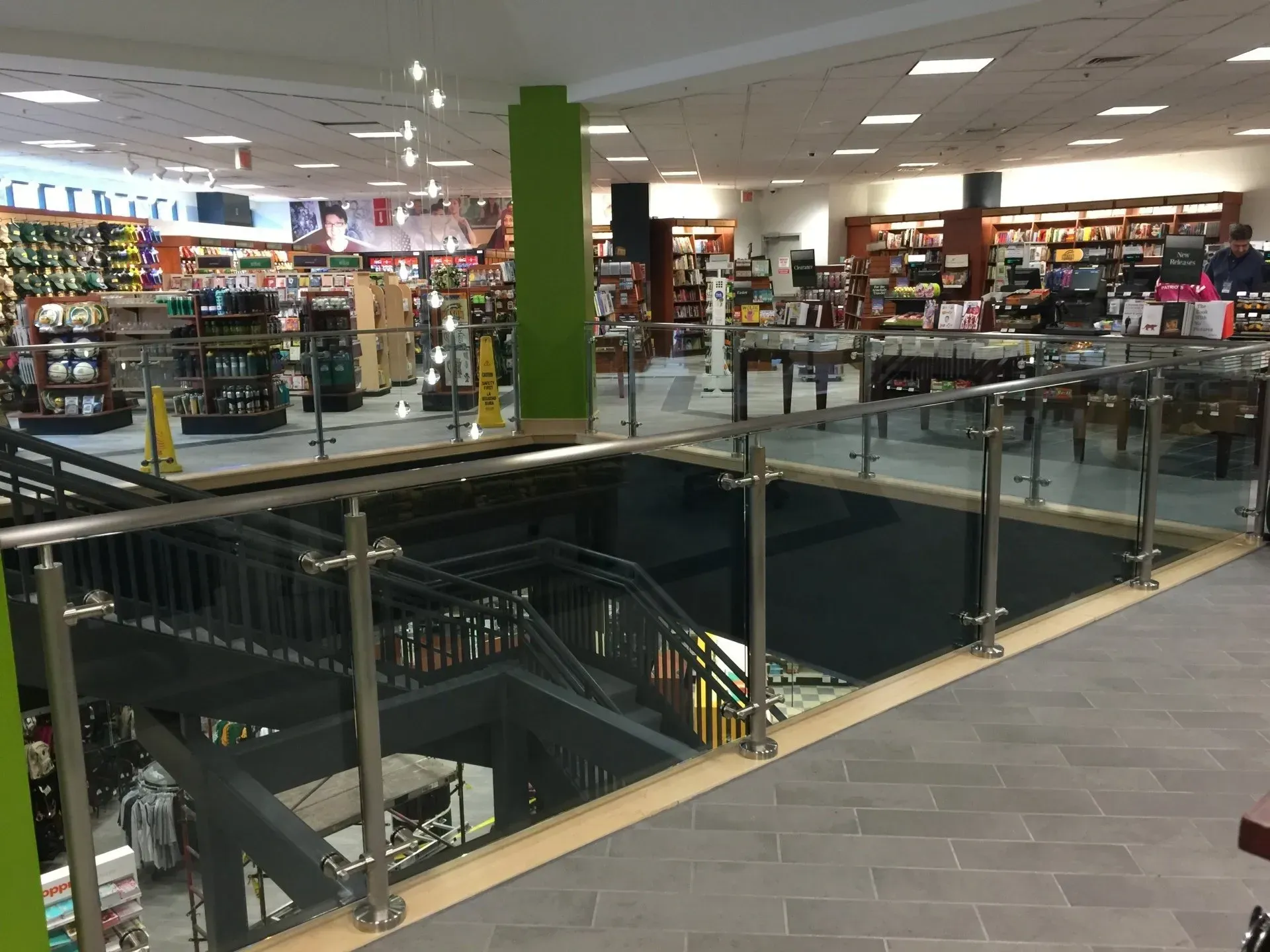 A book store with stairs and a glass railing