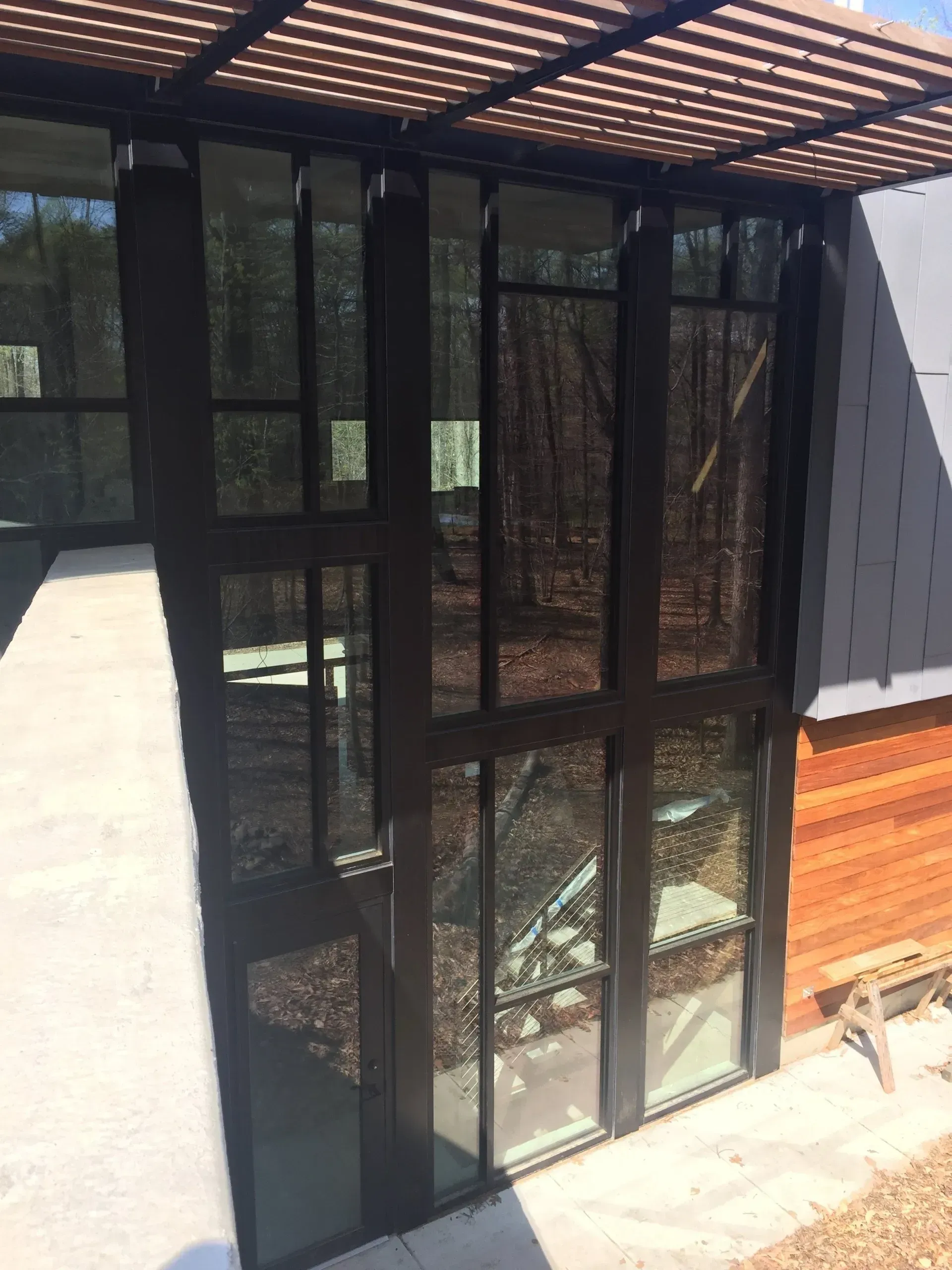 A house with a lot of windows and a wooden roof