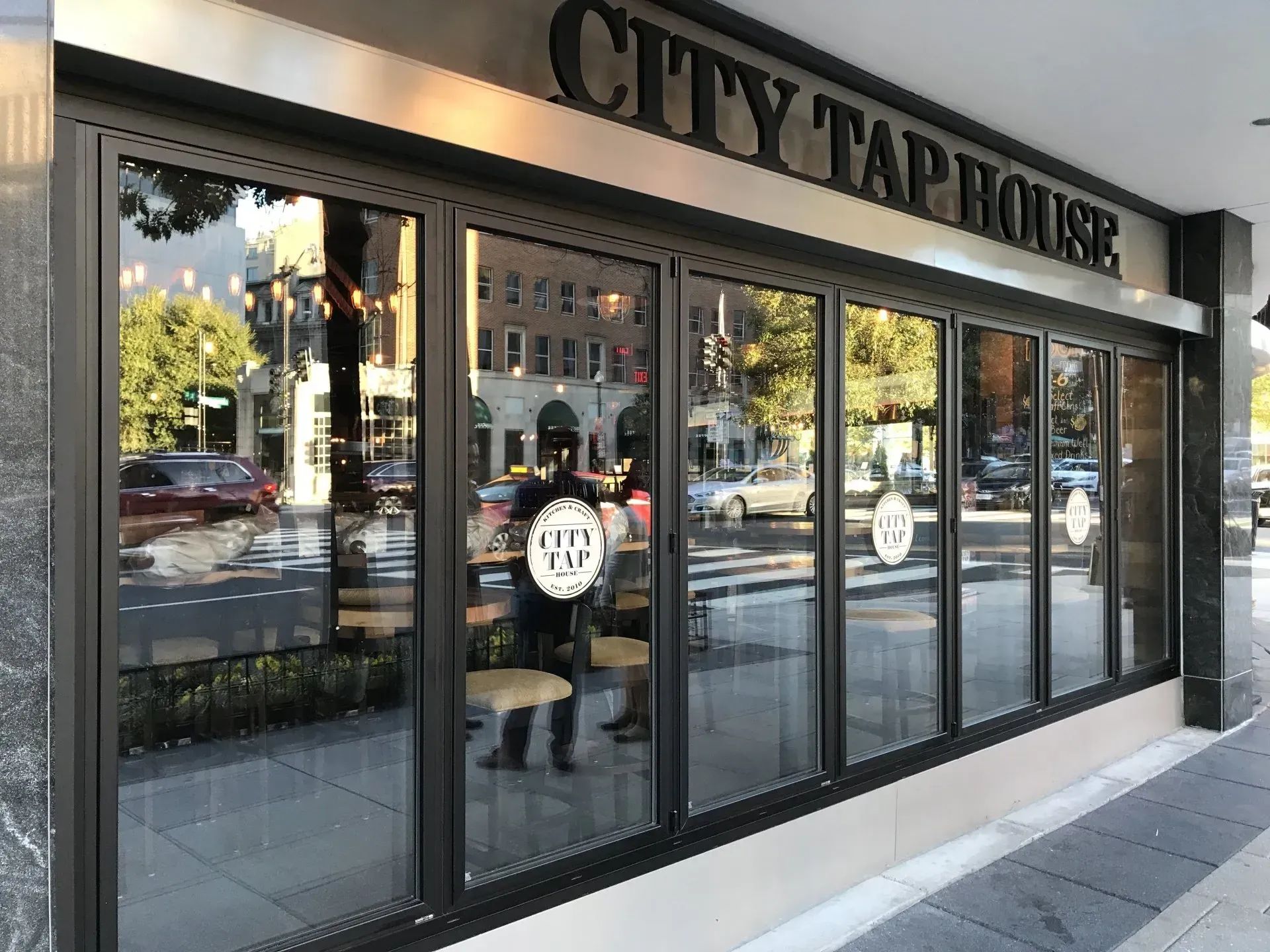 A man is standing in front of a city tap house