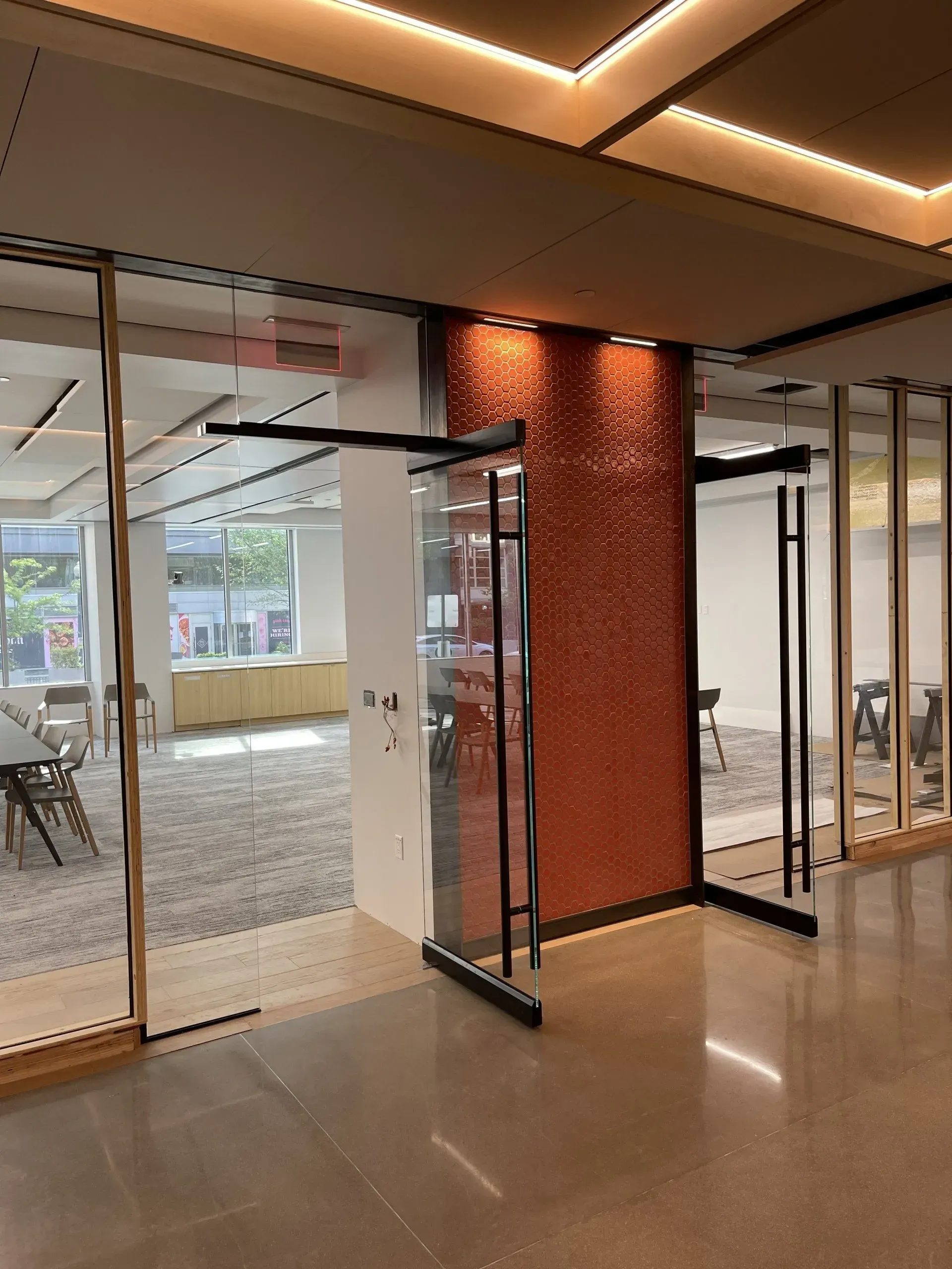 A large room with a lot of windows and a red wall
