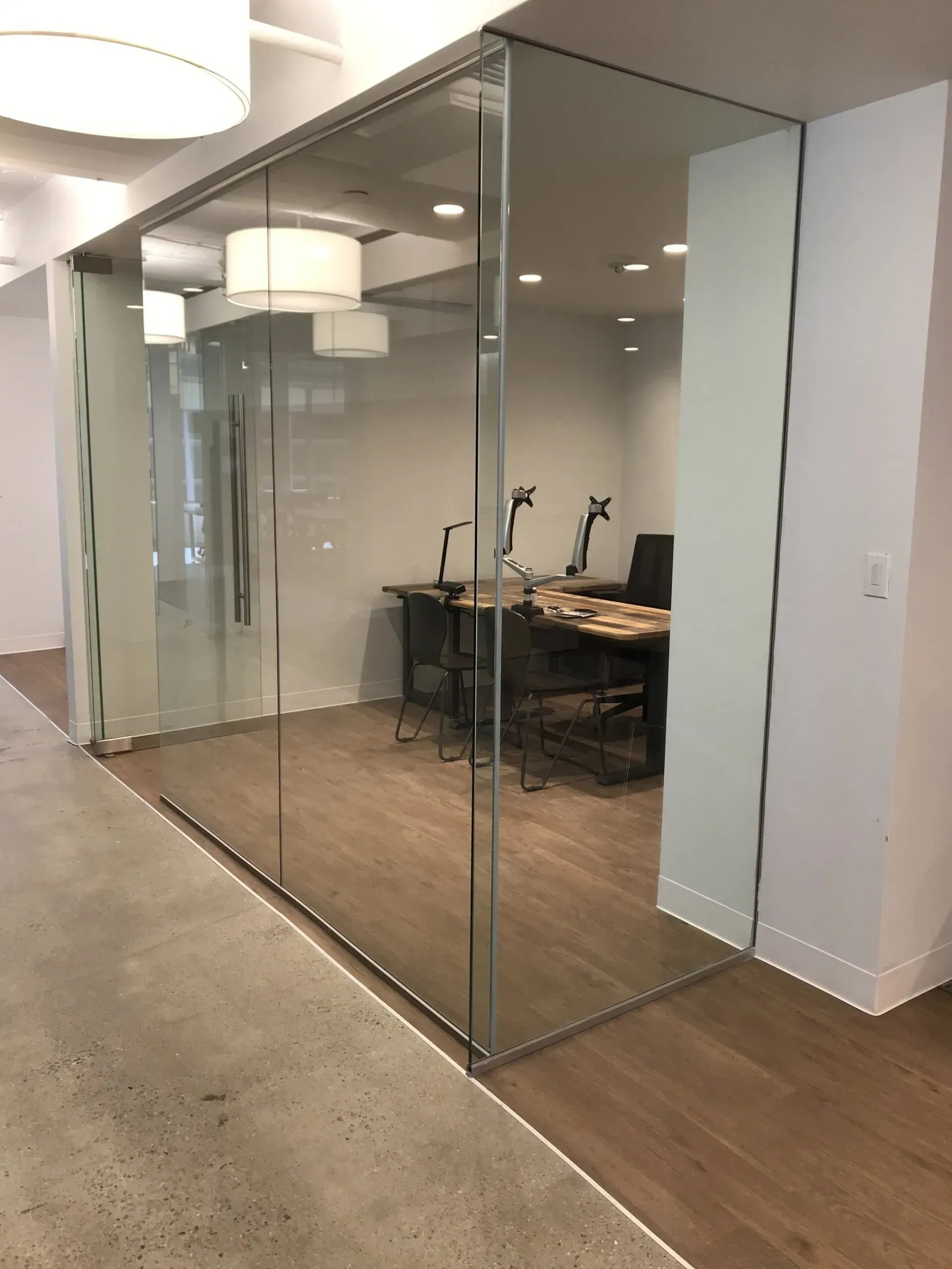 A room with a glass wall and a wooden floor