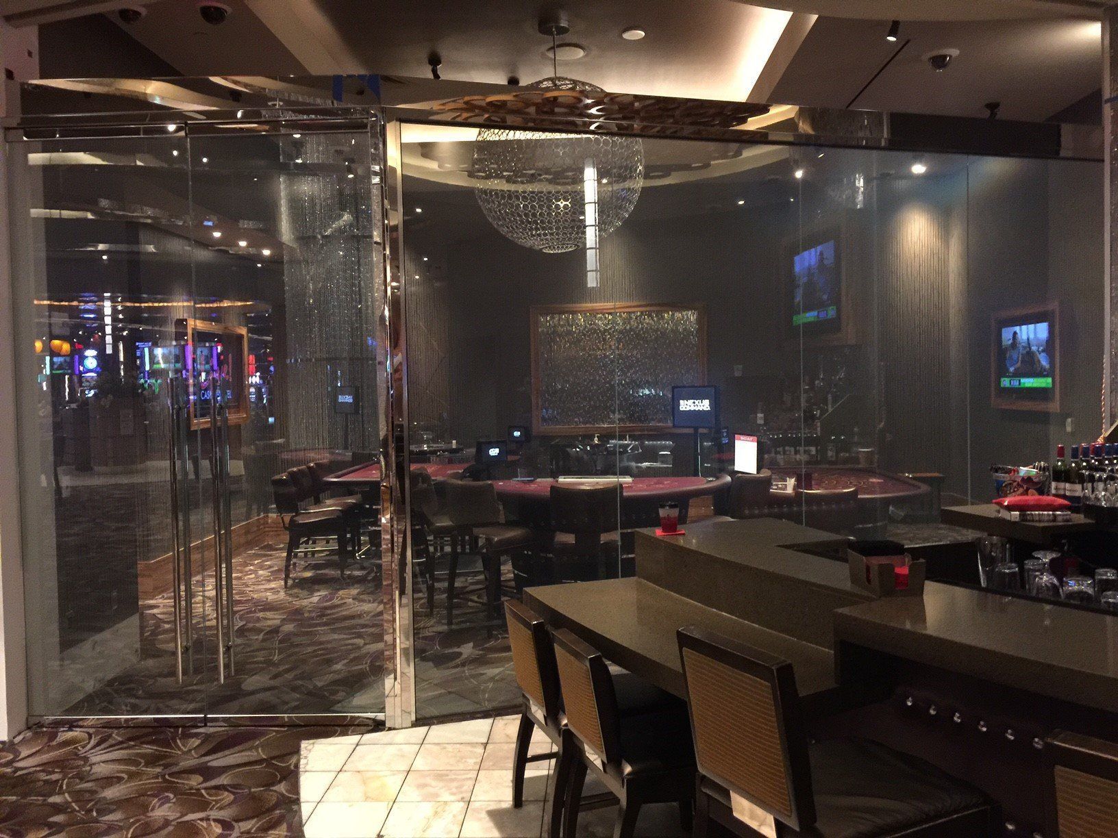 A restaurant with tables and chairs and a bar.