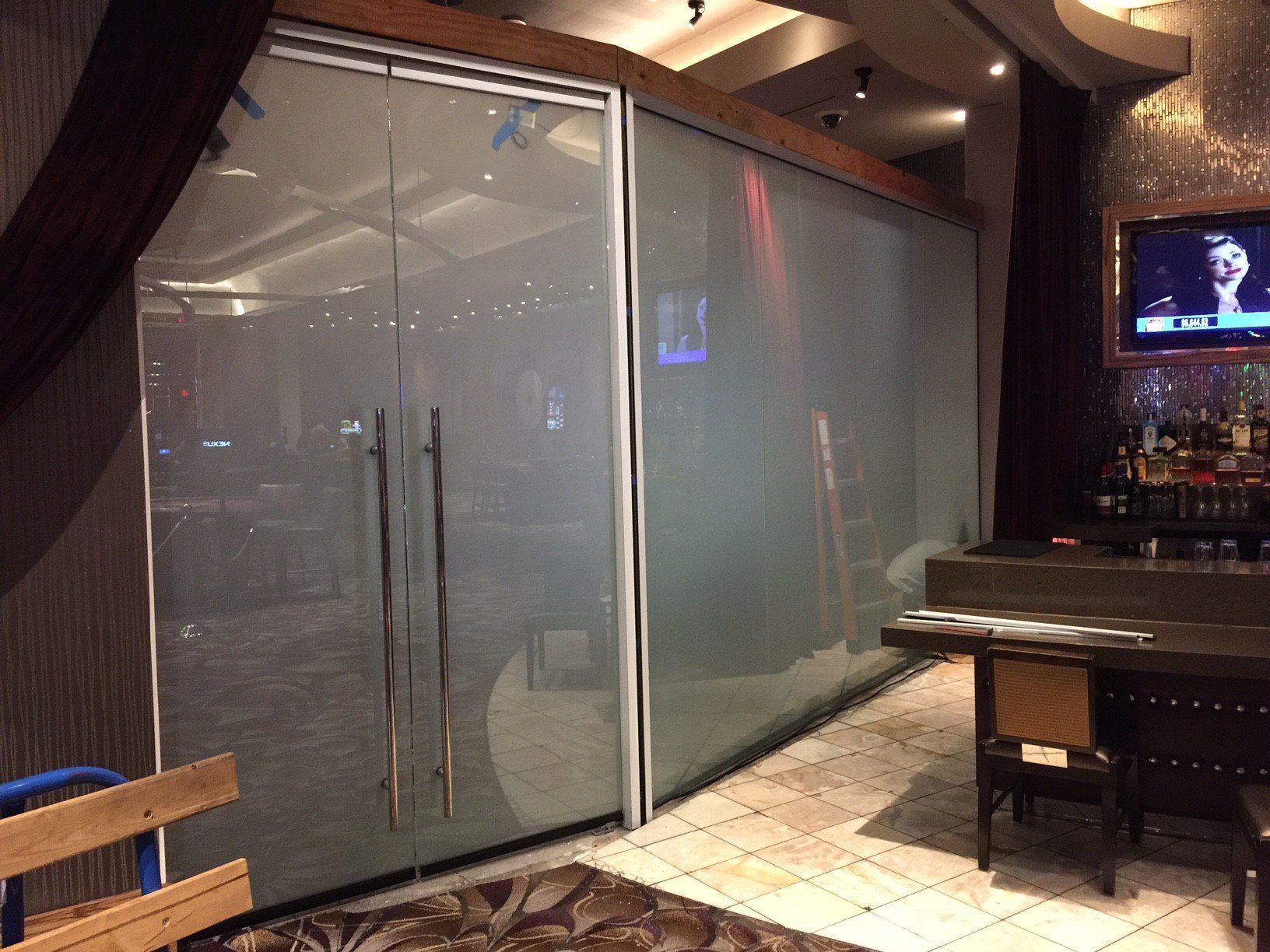 A room with sliding glass doors and a television on the wall.