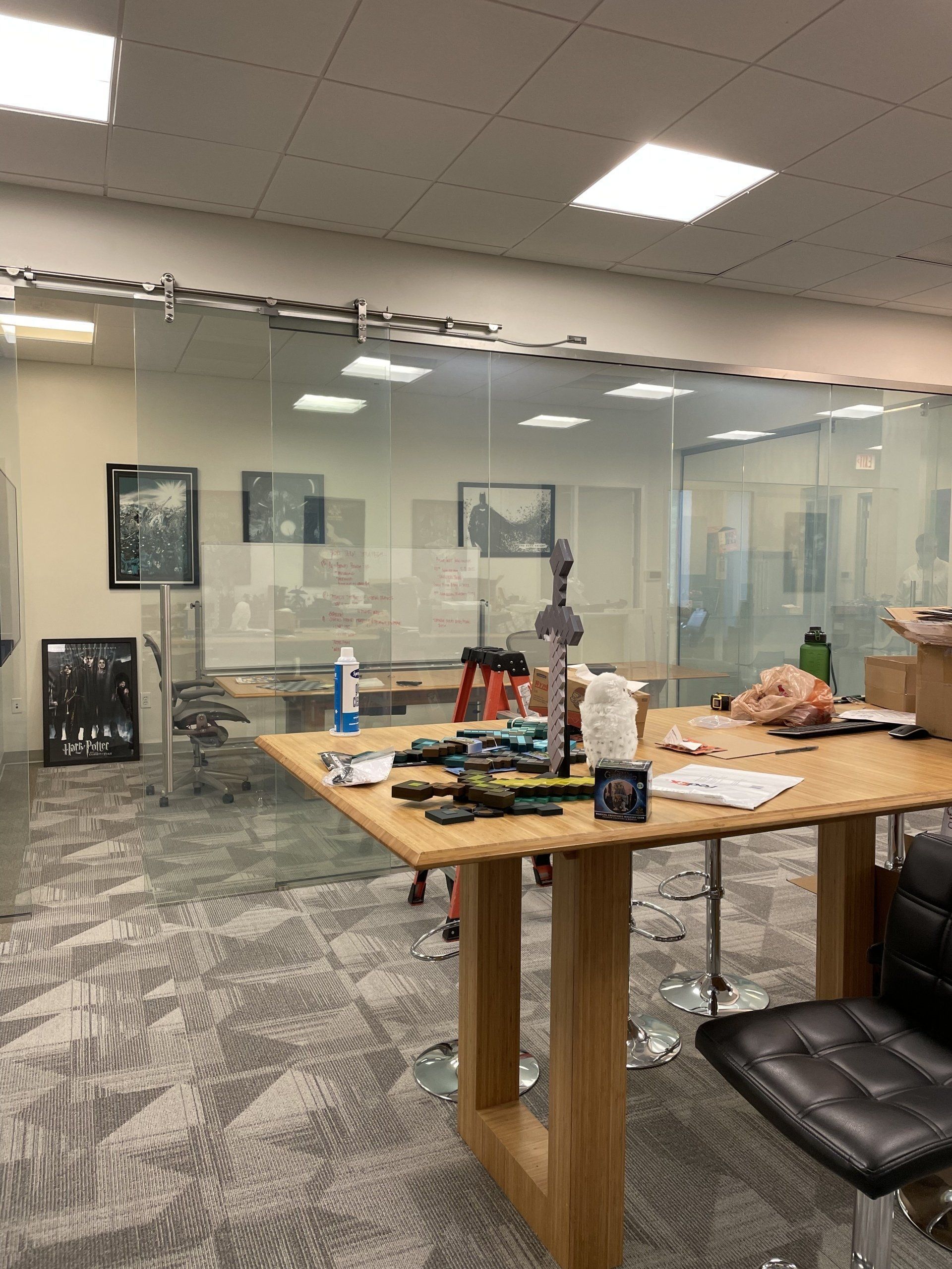 A room with a table and chairs and a glass wall.