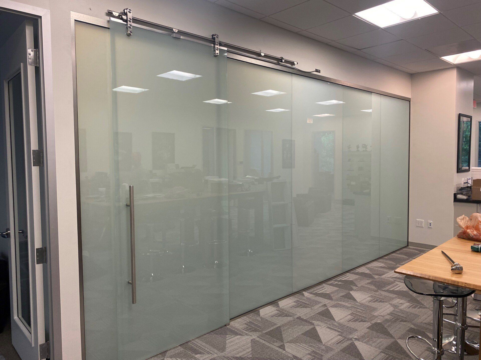 A room with sliding glass doors and a table.