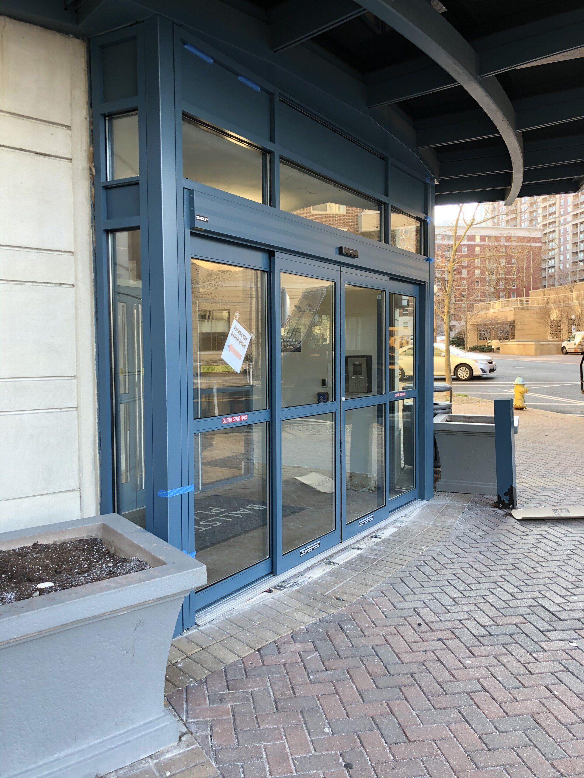 A blue building with a sliding glass door