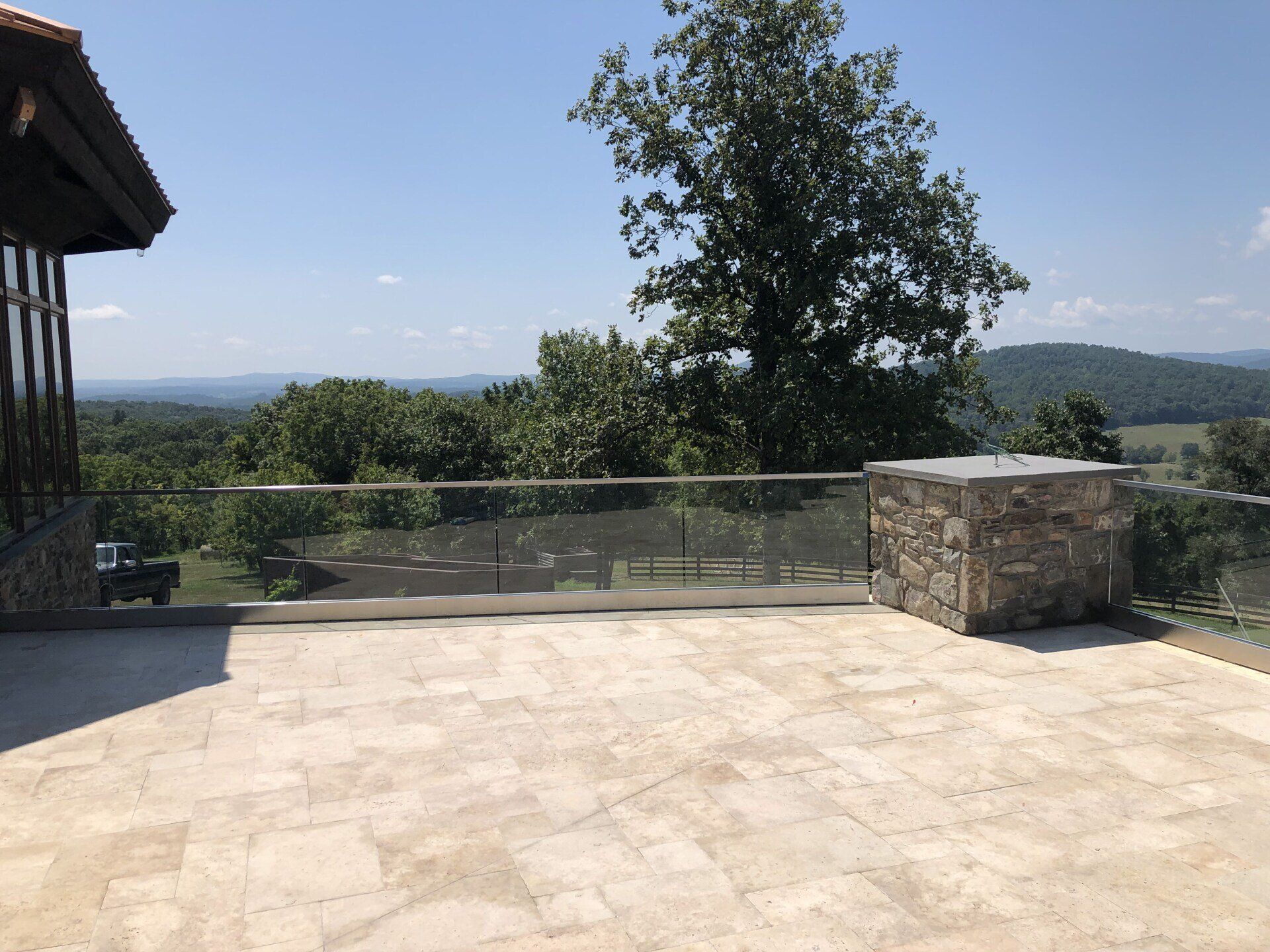A balcony with a view of a forest and mountains