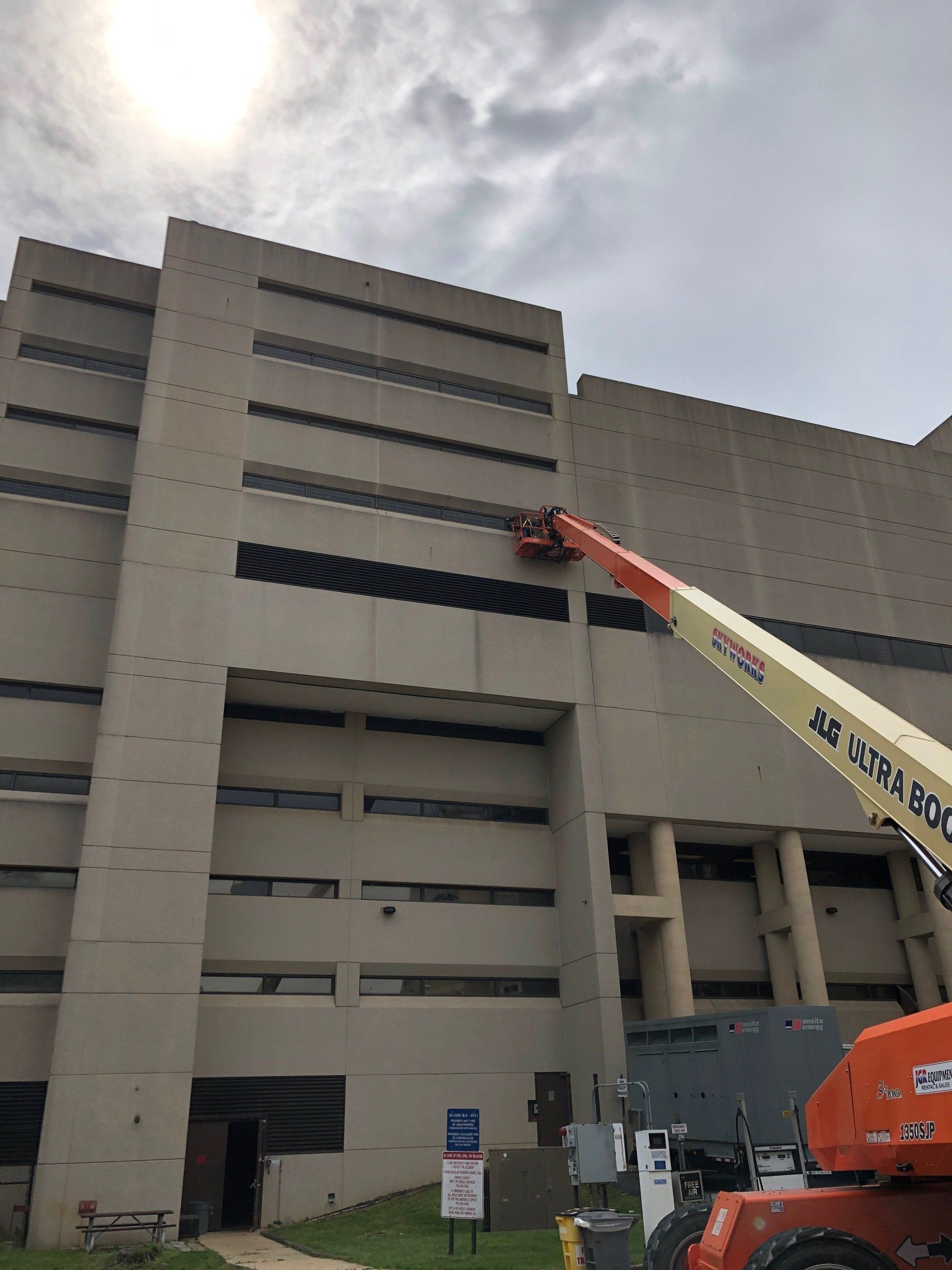 A large building with a crane on the side of it.
