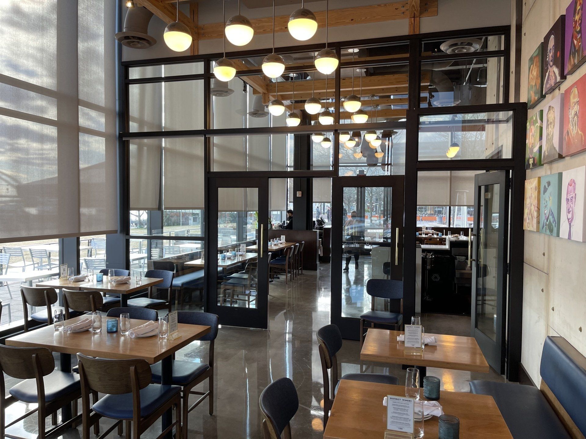 A restaurant with tables and chairs and lots of windows