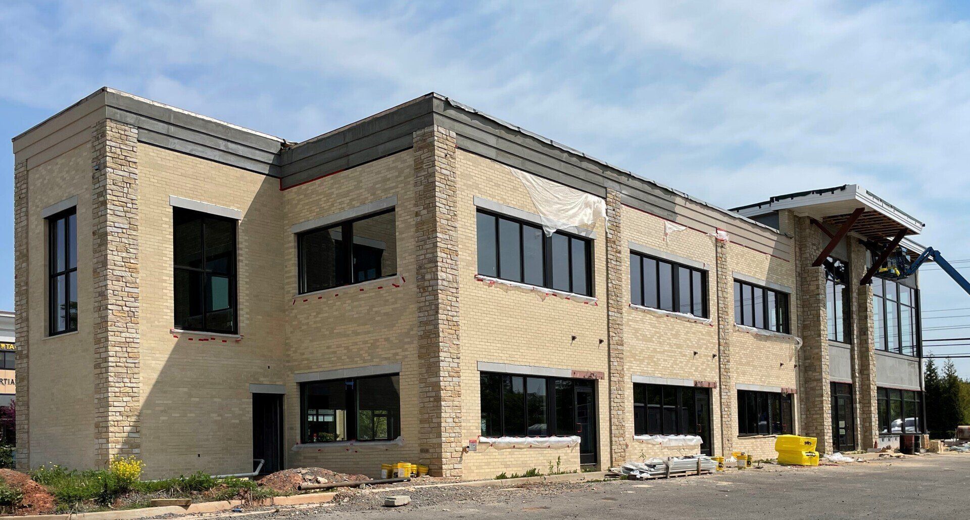 A large brick building with a lot of windows is being built.
