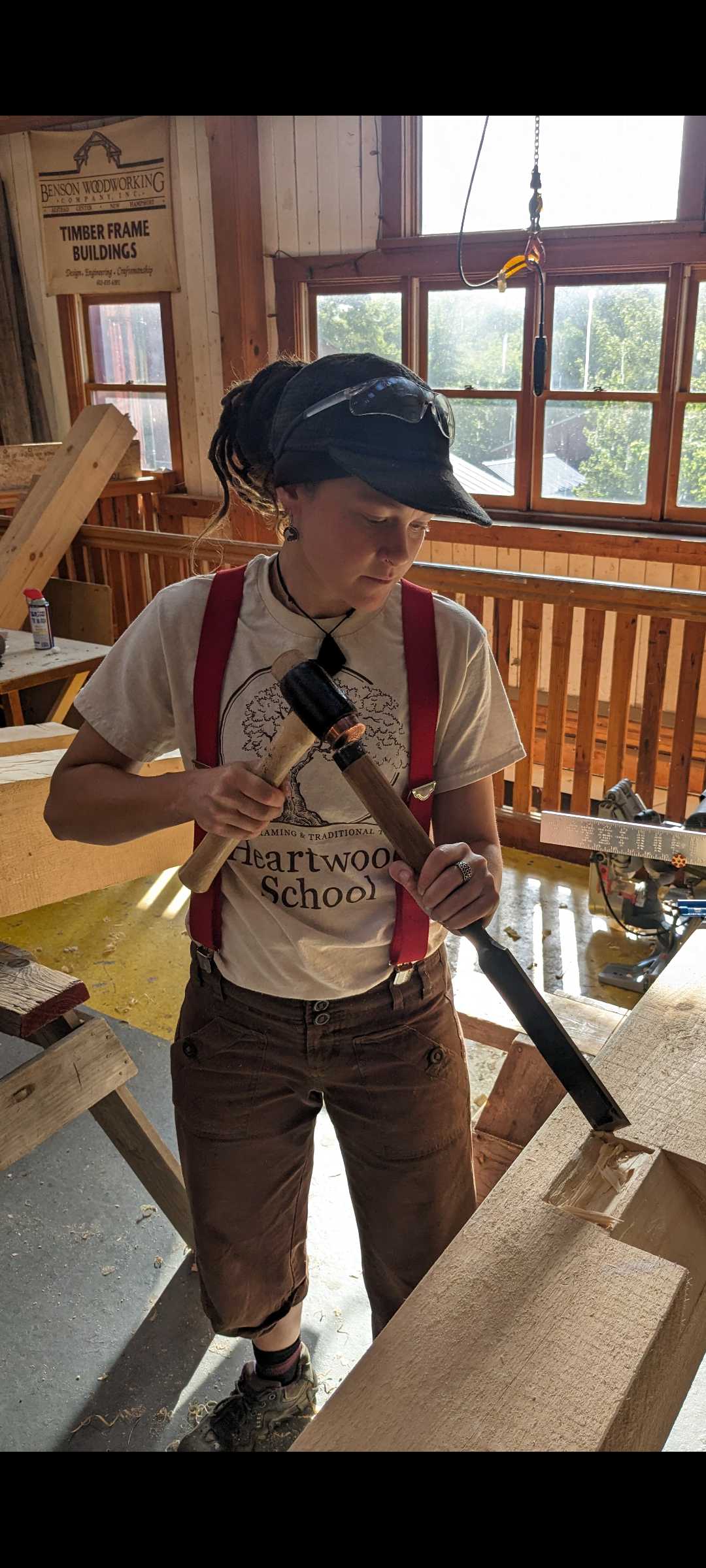 Timber Framing Apprentice cutting a step-lap rafter seat