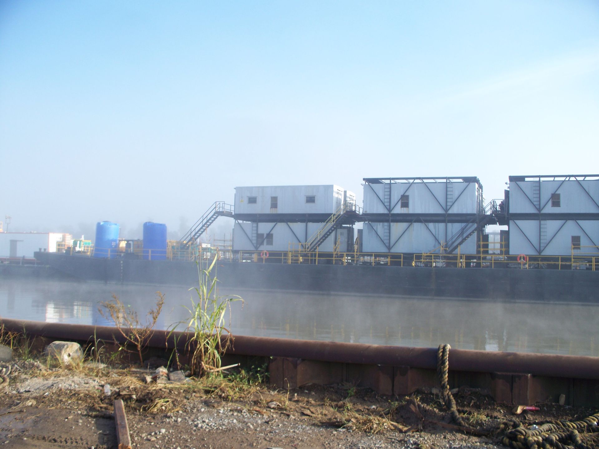 A large boat is docked next to a body of water.