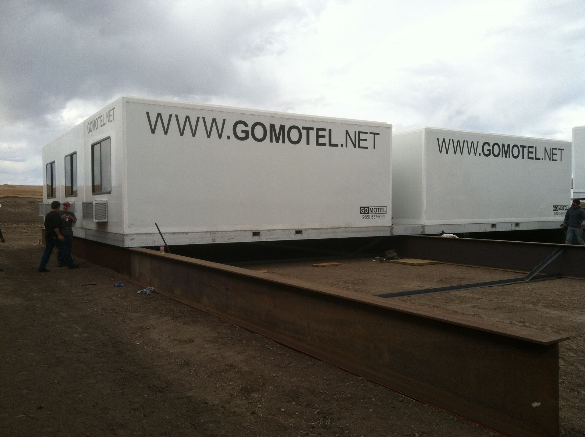 Two white trailers with www.gomotel.net written on them