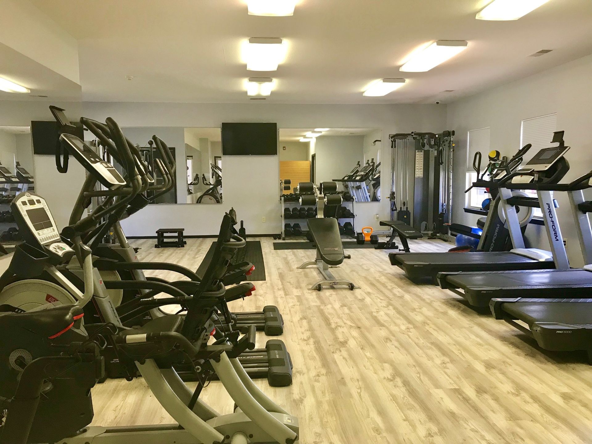 a large gym filled with a variety of exercise equipment .