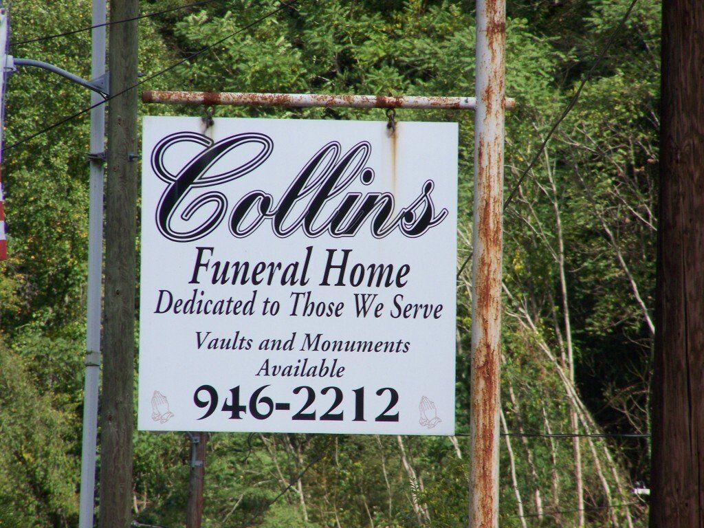 A sign for collins funeral home dedicated to those we serve
