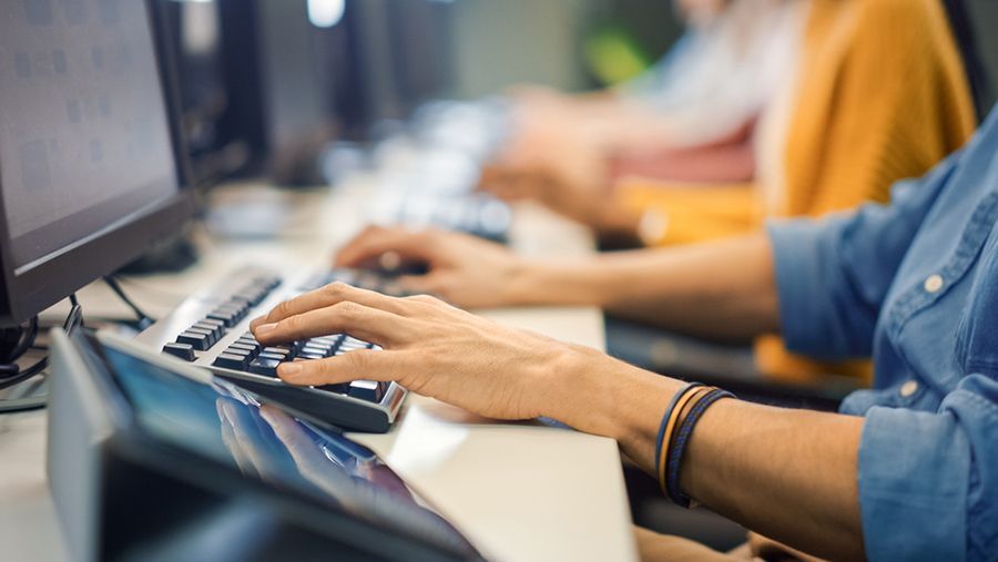 A Person is Typing on a Keyboard in Front of a Computer — Computers NQ in Aitkenvale, QLD