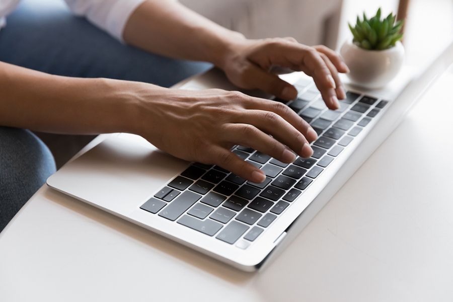 A Person is Typing on a Laptop Computer — Computers NQ in Aitkenvale, QLD
