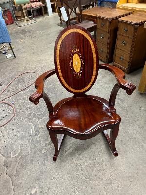 A vintage-style tufted armchair with beige velvet upholstery and a dark wooden frame, set against a dark grey wall.