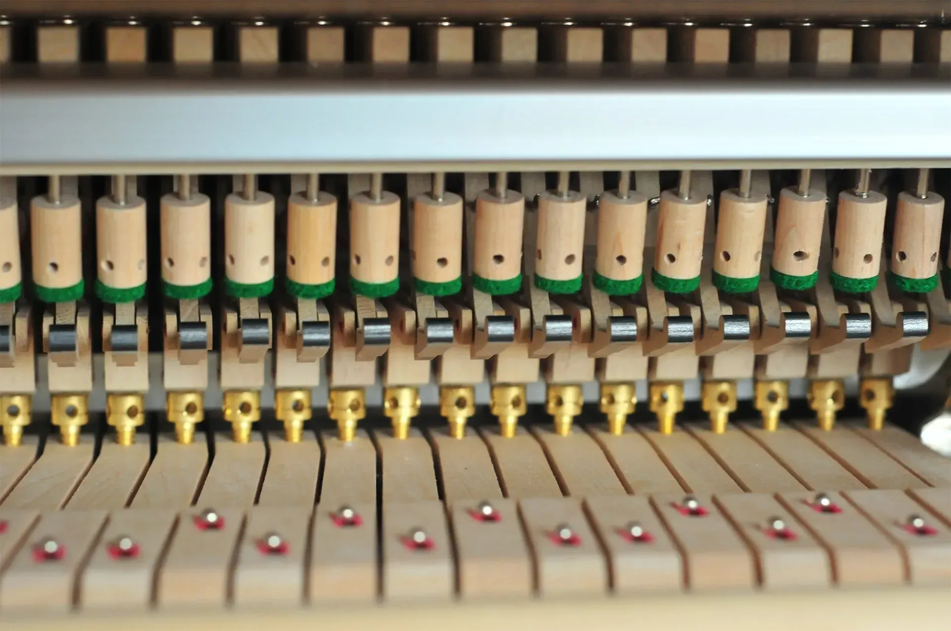A close up of the inside of an upright piano