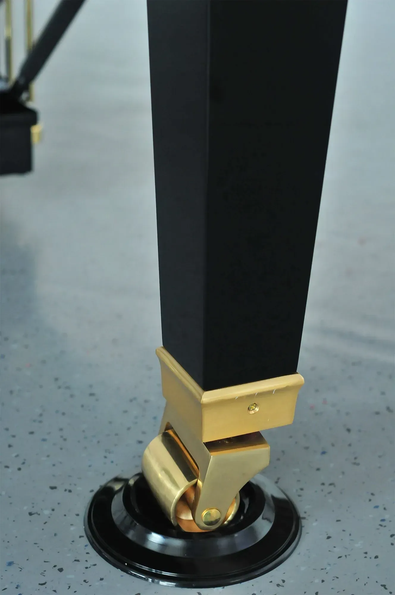 A close up of a piano leg with wheels on it