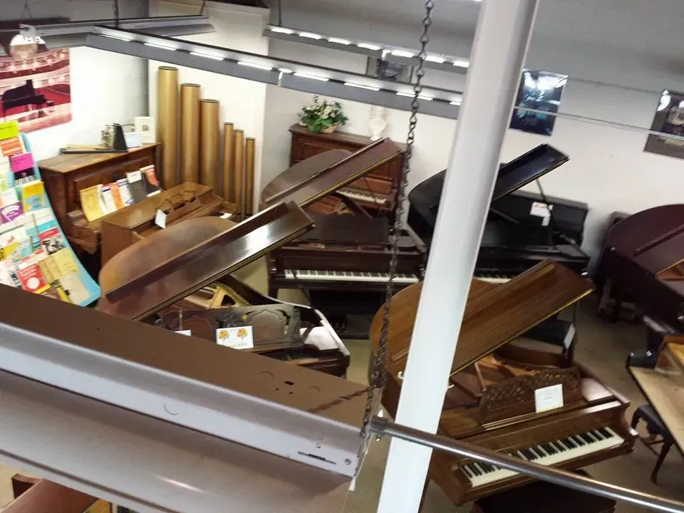 An aerial view of a piano store with many pianos
