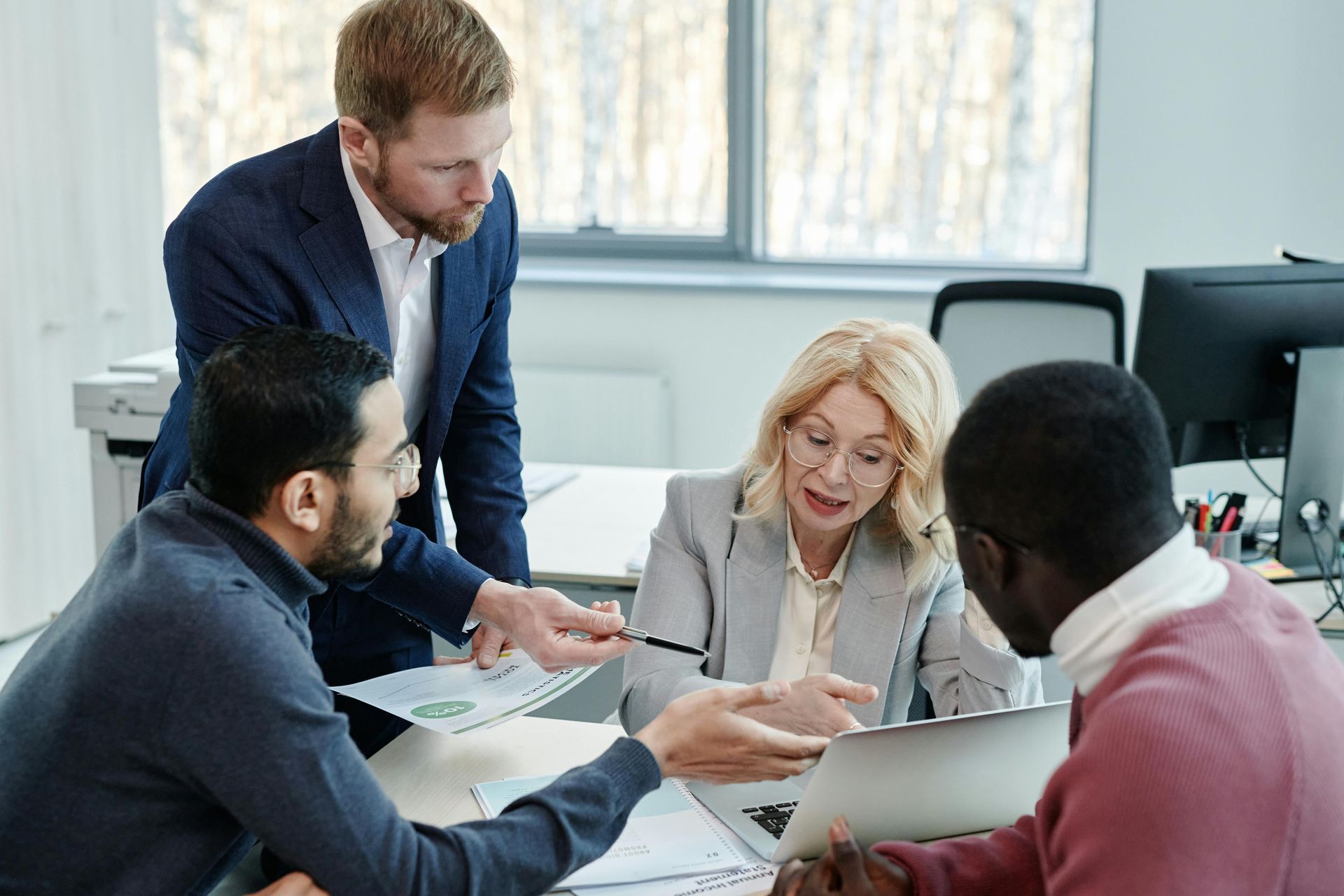 A group of people are having a meeting in an office.