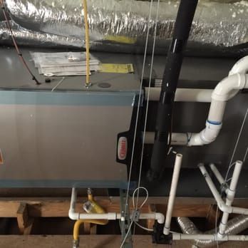 There are many pipes hanging from the ceiling in this room.