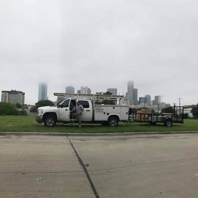 A white truck is parked on the side of the road.