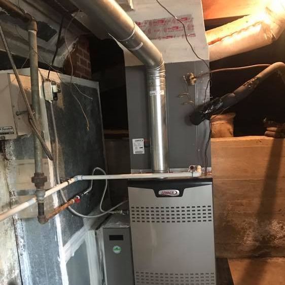 A furnace is installed in a basement.