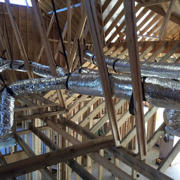 A ceiling with a lot of pipes hanging from it