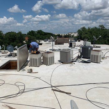 A man is working on the roof of a building.