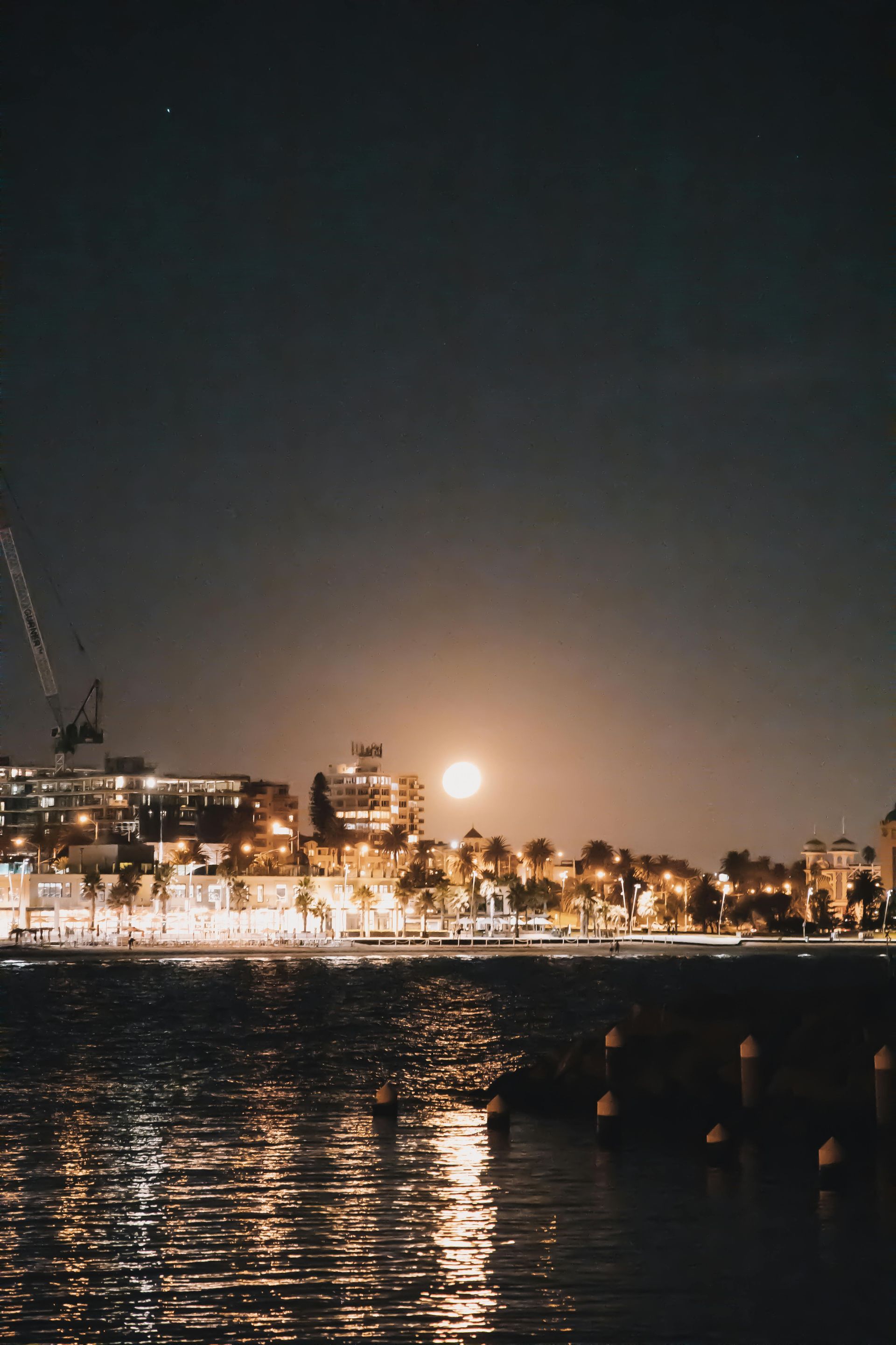 night view of  St Kilda, with city lights and water reflections