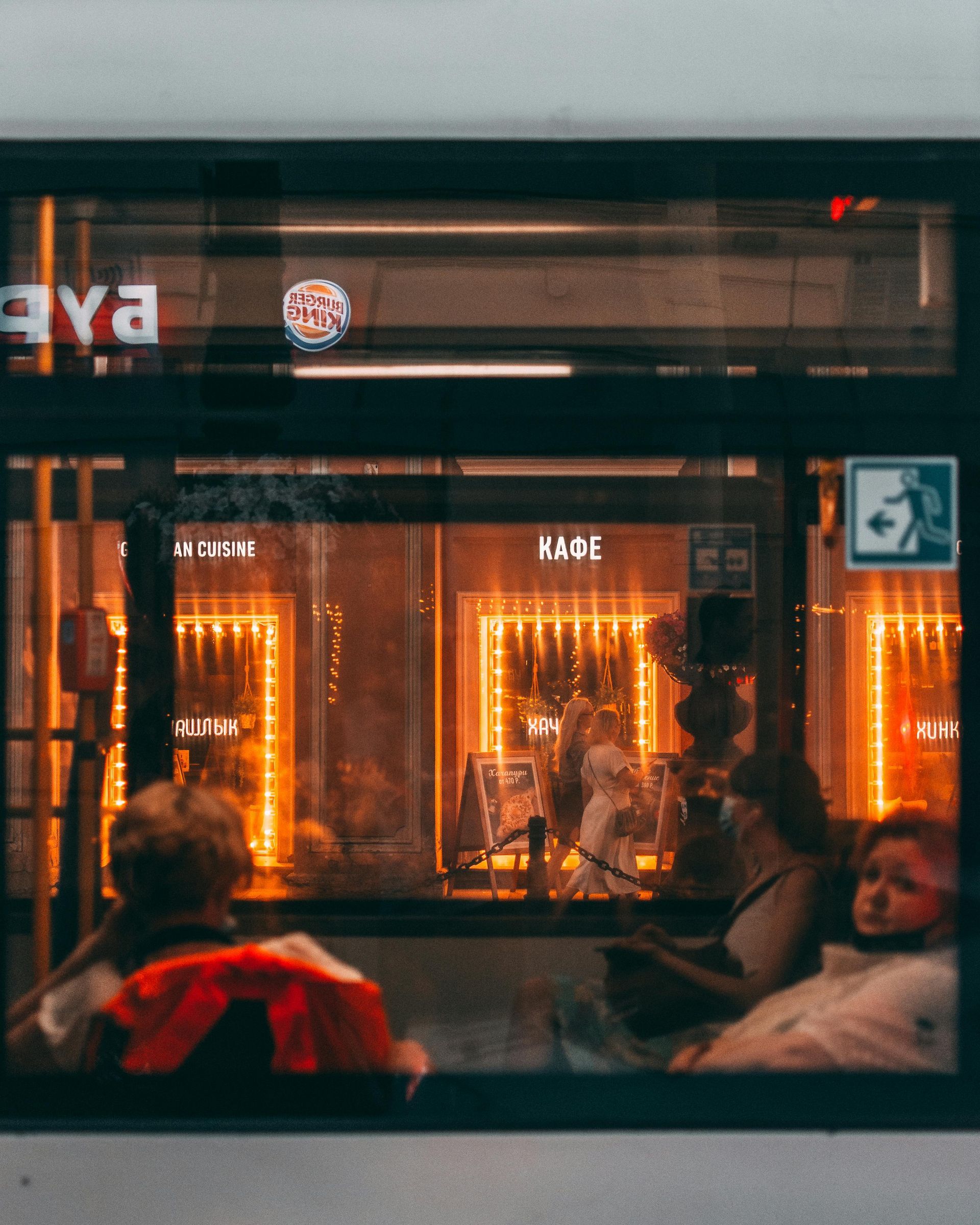  café in St Kilda with warm lighting and people relaxing inside