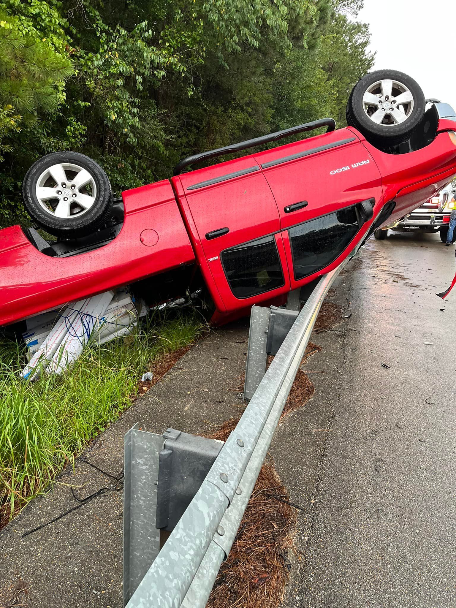 Red truck flipped over after the accident