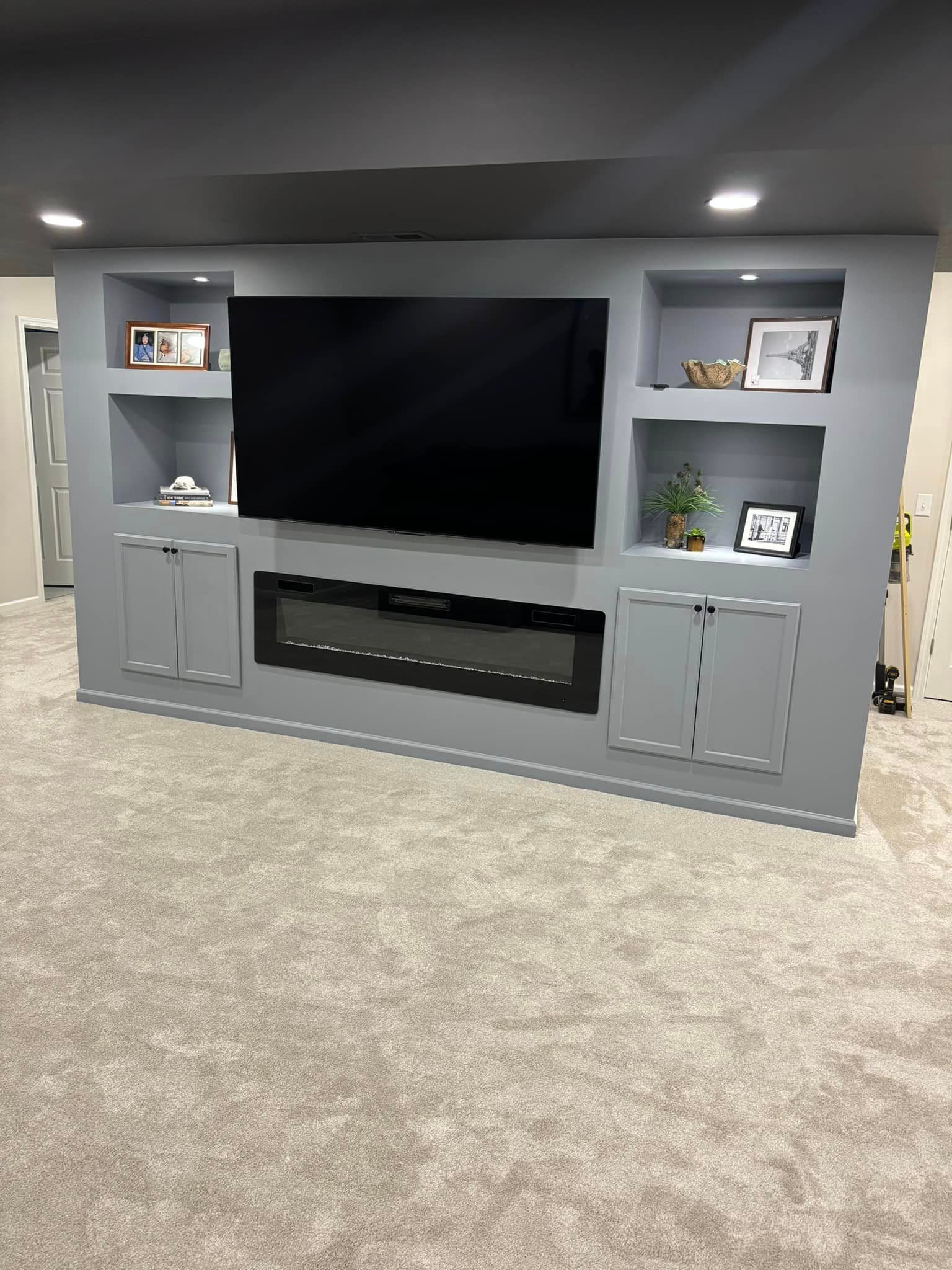 A living room with a flat screen tv and a fireplace.