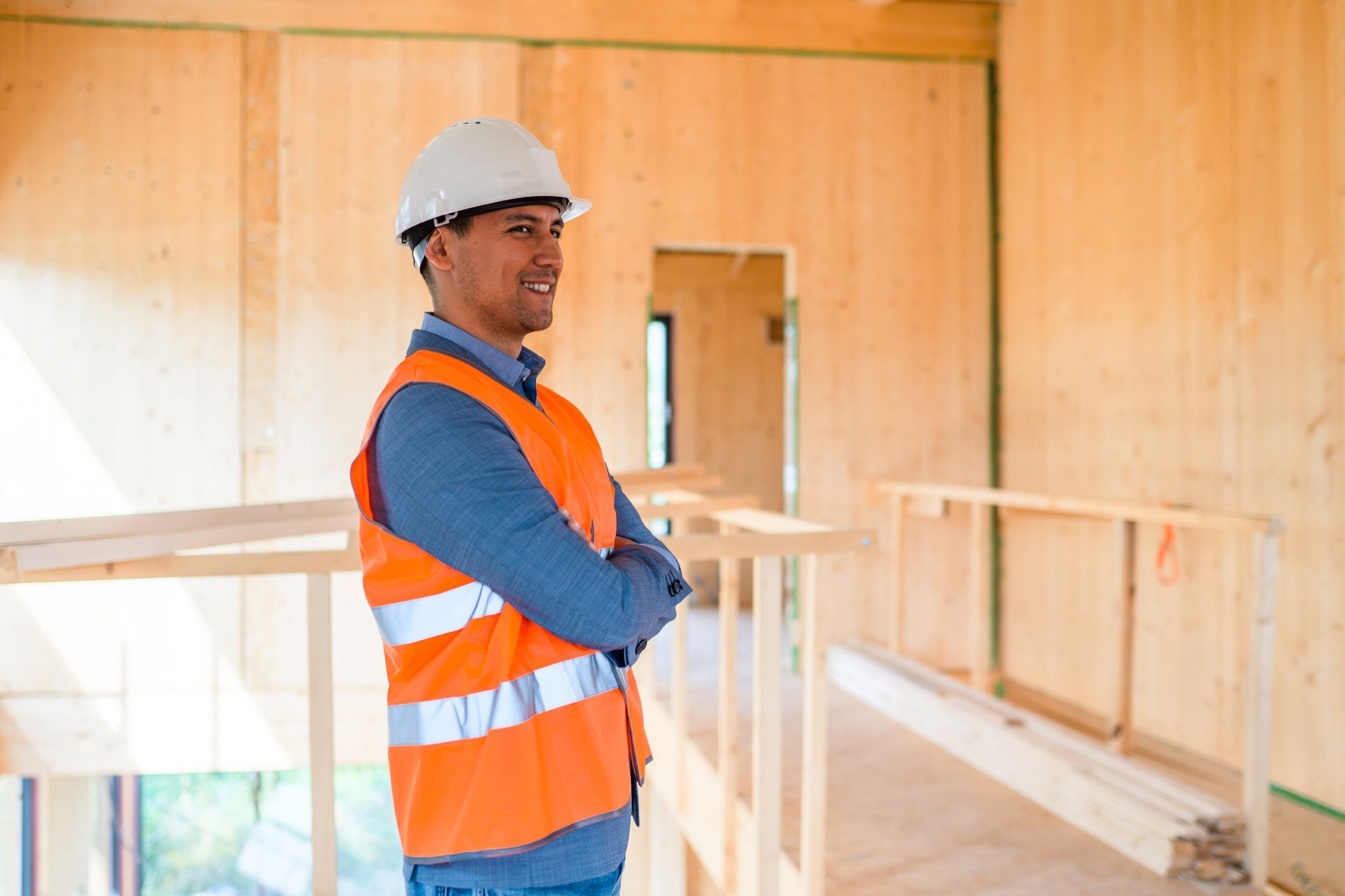 A man wearing a white hard hat is engaged in a commercial construction general contractor.