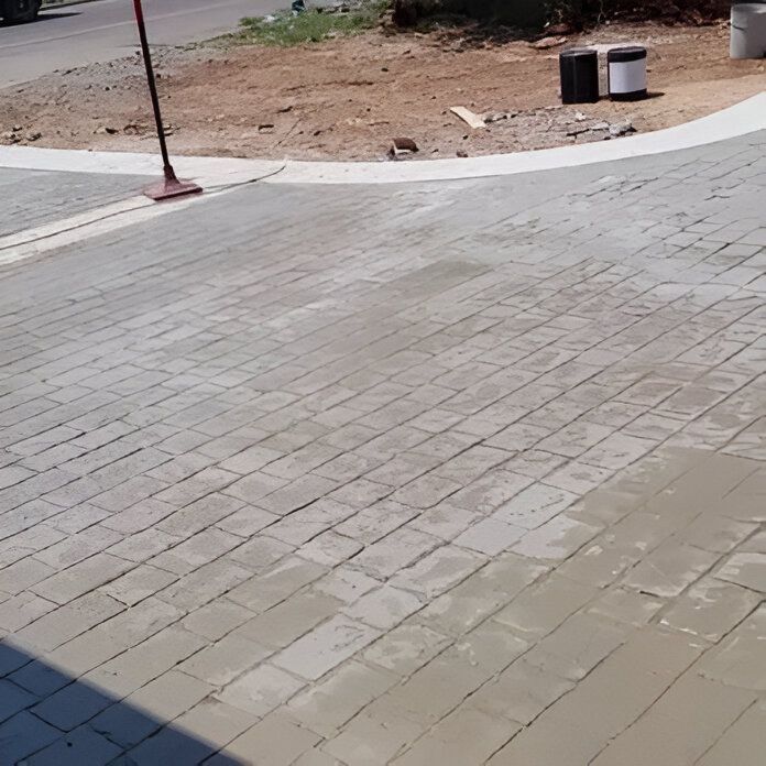 Freshly grouted brick pavers on a driveway.