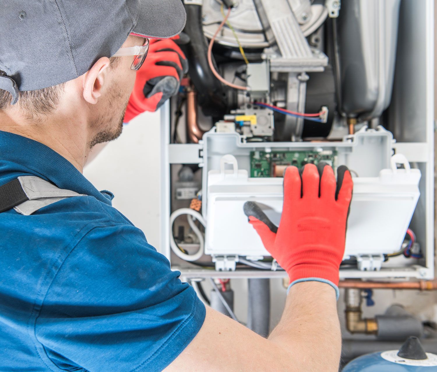 Technician Fixing the Problem with the Residential Heating Equipment