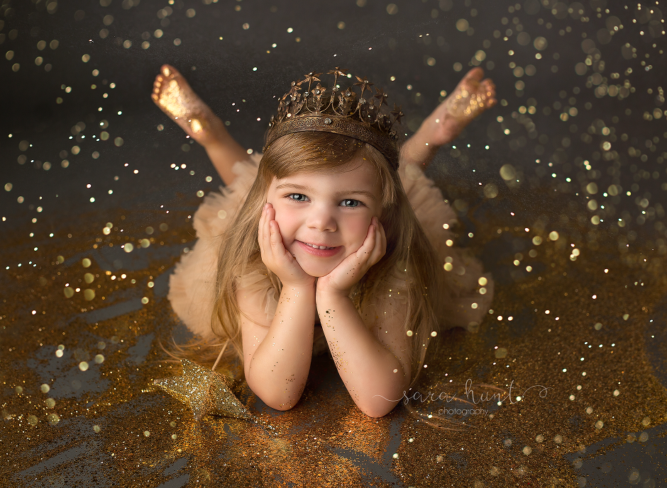 Girl wearing crown while laying on the floor — Pearland, TX — Sara Hunt Photography
