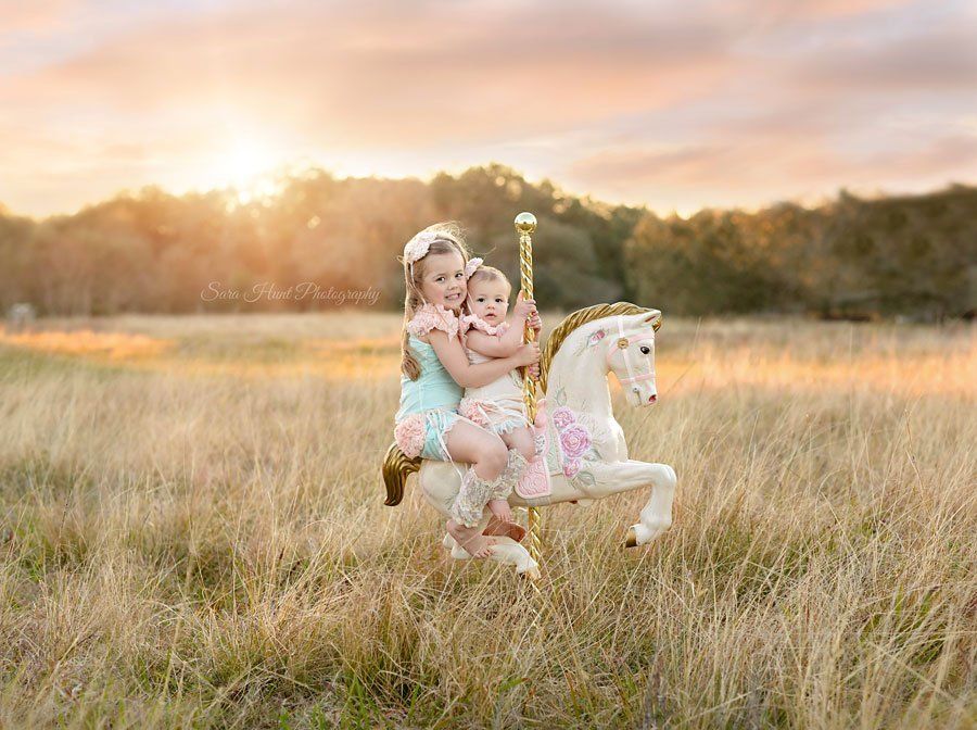 Two girls riding a carousel horse — Pearland, TX — Sara Hunt Photography Two girls riding a carousel horse — Pearland, TX — Sara Hunt Photography