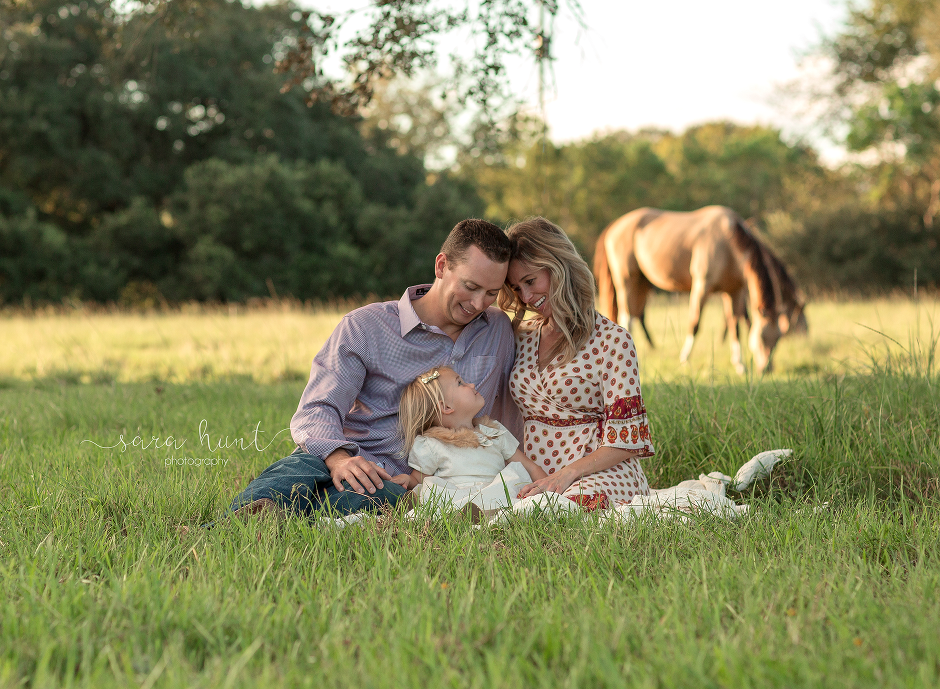 Parents looking at their daughter — Pearland, TX — Sara Hunt Photography