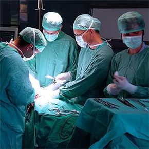 A group of surgeons are performing surgery on a patient