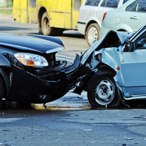 A black car and a blue car are involved in a car accident