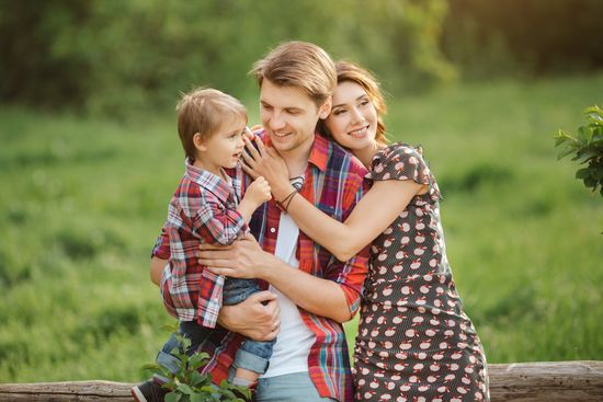 Happy family in a park — Milton, VT — Barsalow Insurance