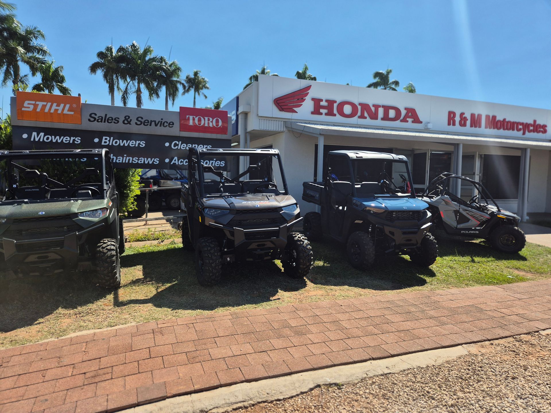 A Red and Black ATV is Parked in Front of a R & M Motorcycles Store — R & M Motorcycles in Katherine, NT