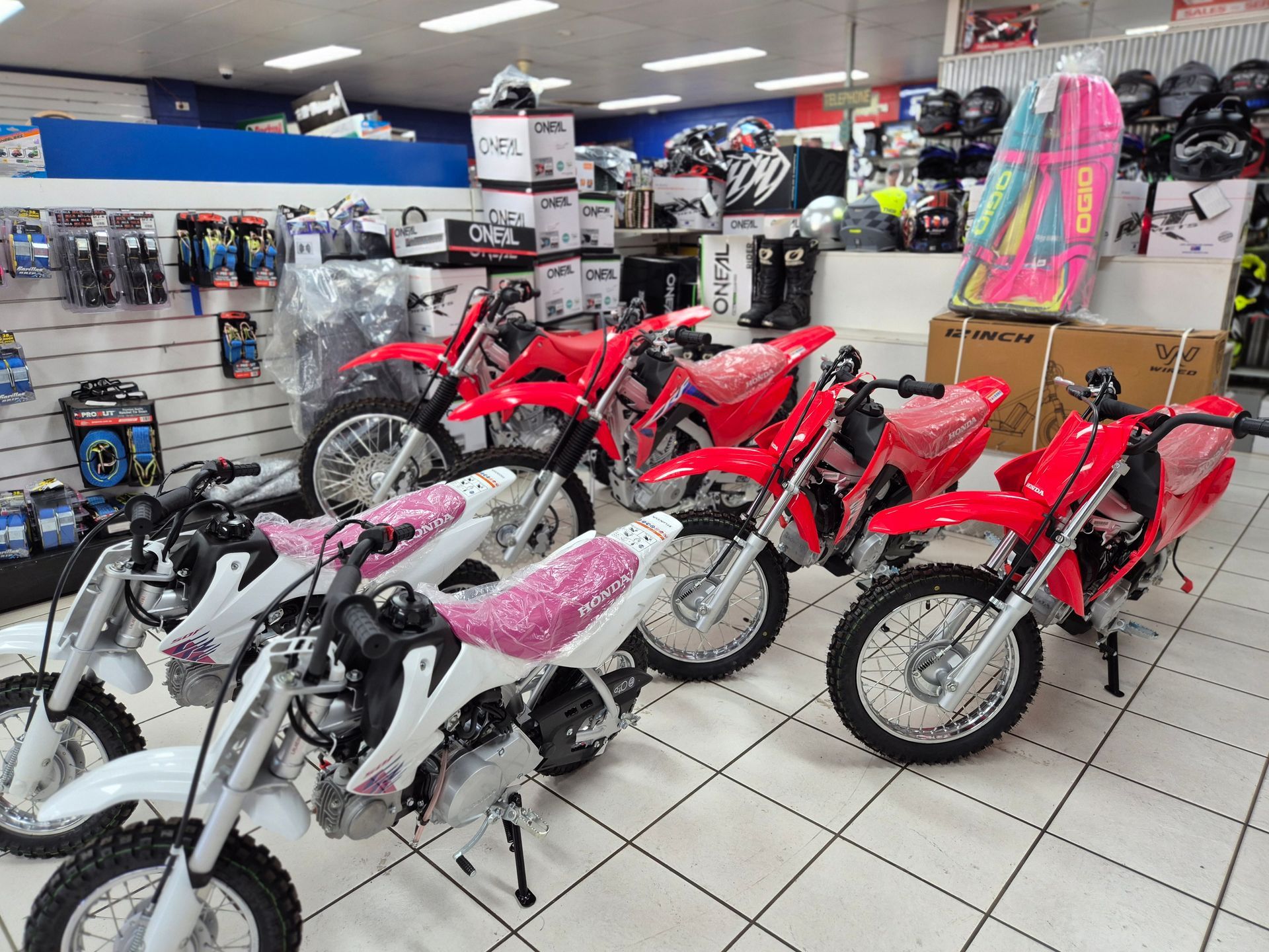 A Row of Motorcycles and ATVs Are Lined Up in a Store — R & M Motorcycles in Katherine, NT