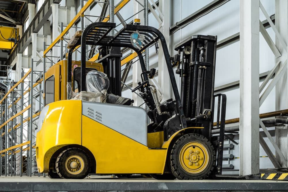 Yellow and gray forklift in a warehouse.